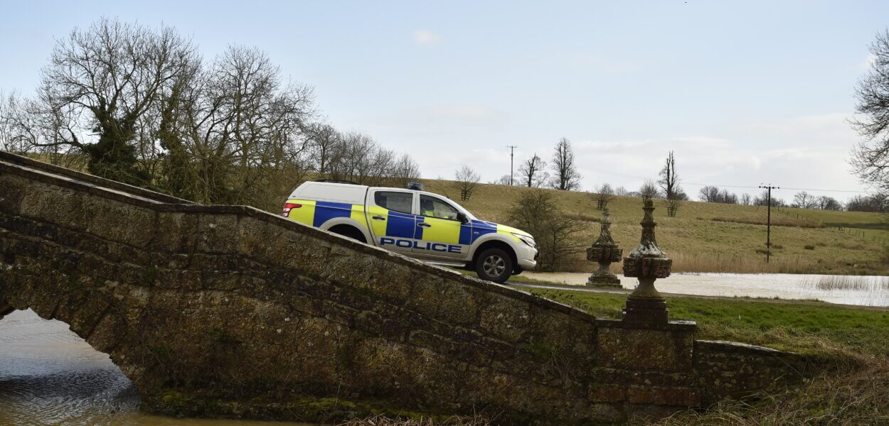 Sideview of police van driving over bridge