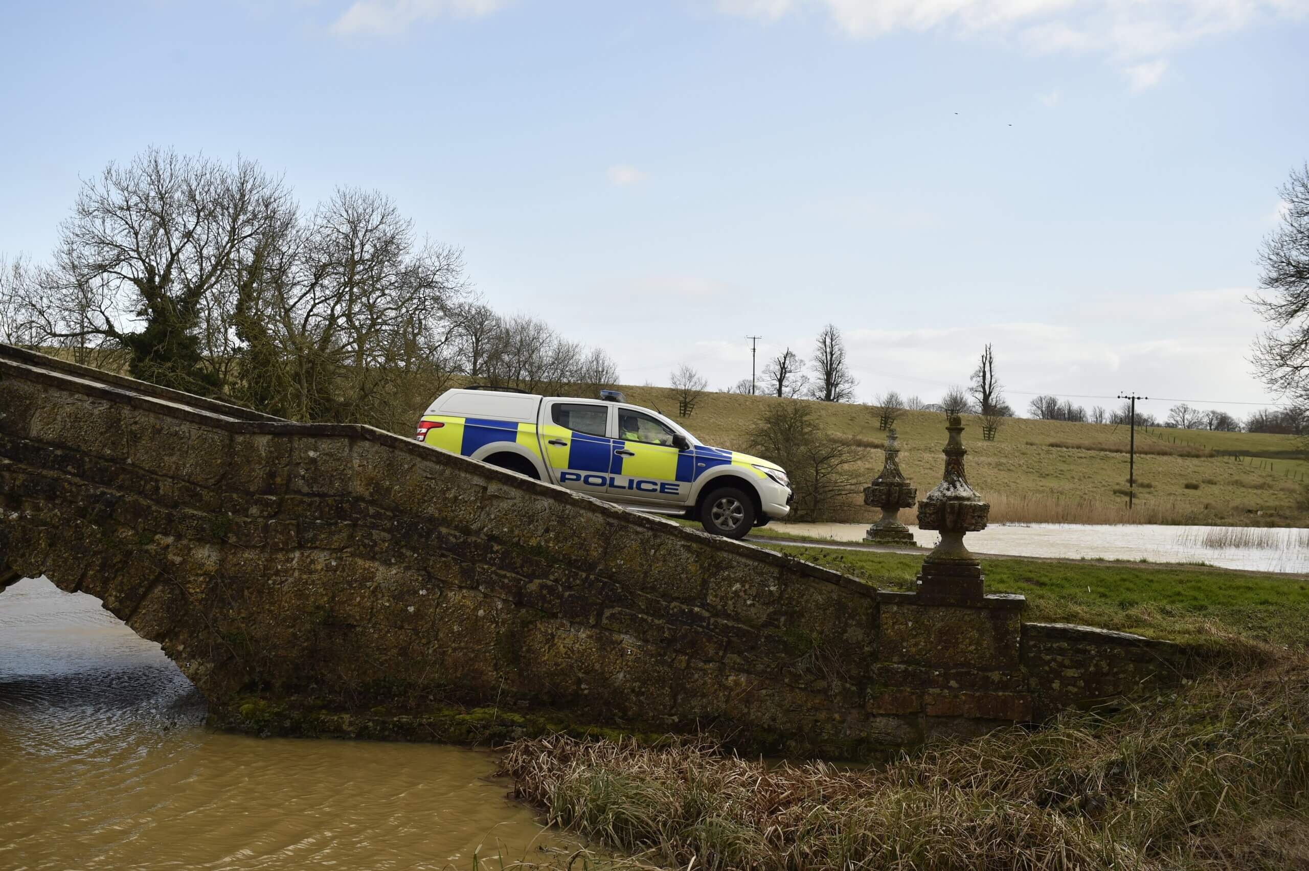 Sideview of police van driving over bridge