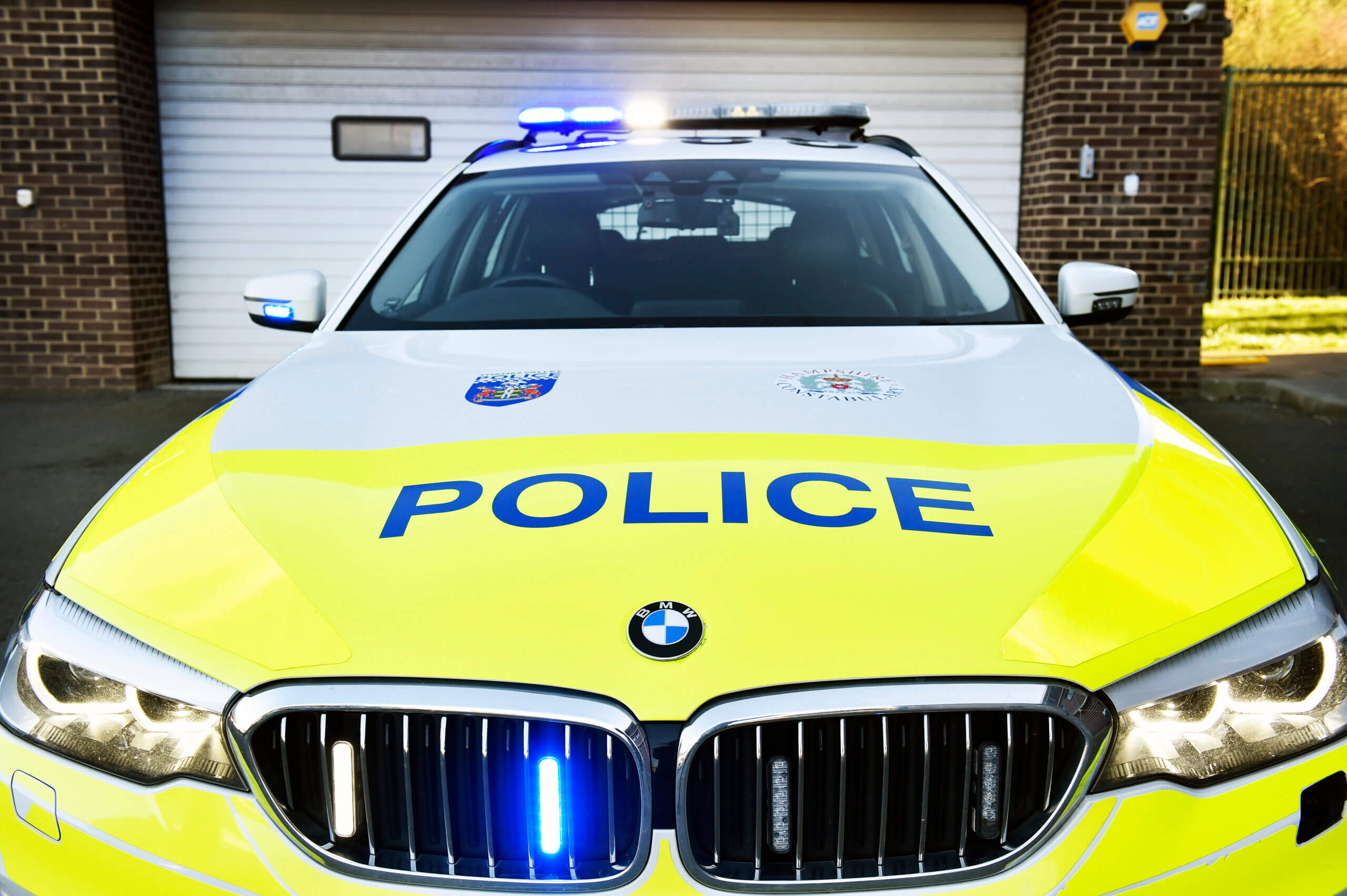 Bonnet view of police car with lights on