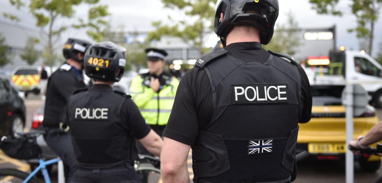 Rear view of uniformed police officers