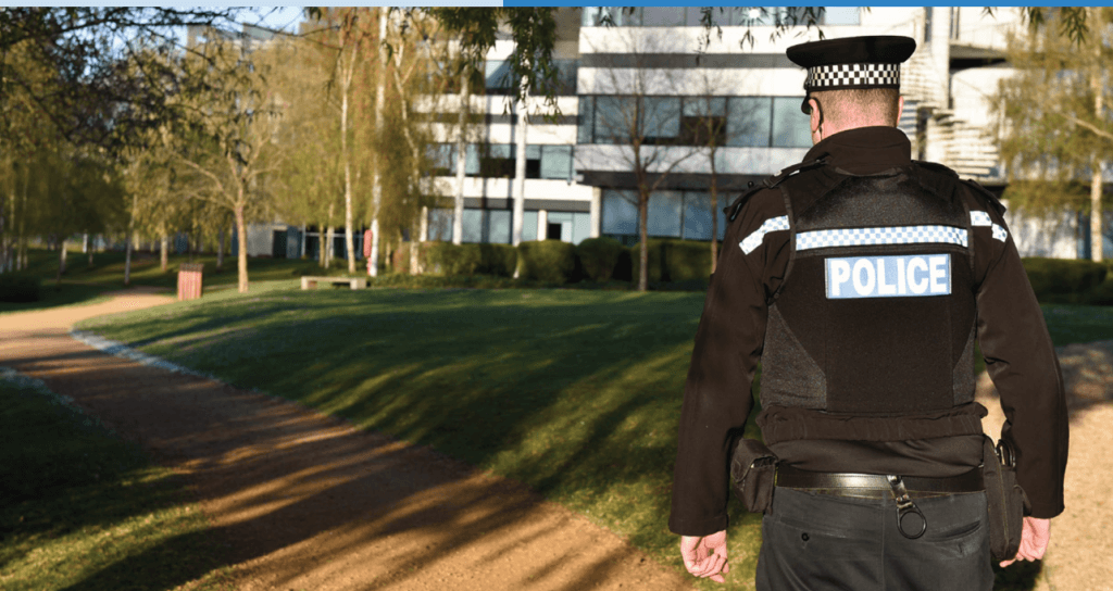 Back of police officer on patrol in a neighbourhood