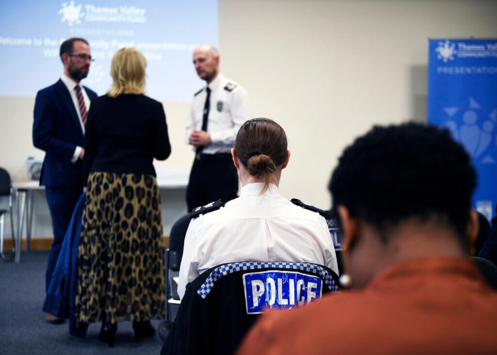 Photo of PCC and Chief Constable talking to woman with Police uniform in foreground