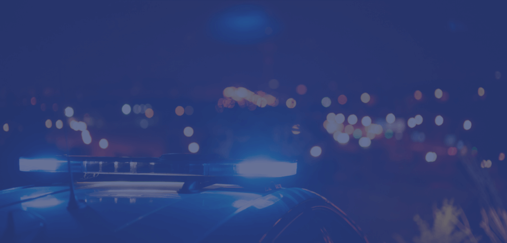 Image of police car siren lights on blue background