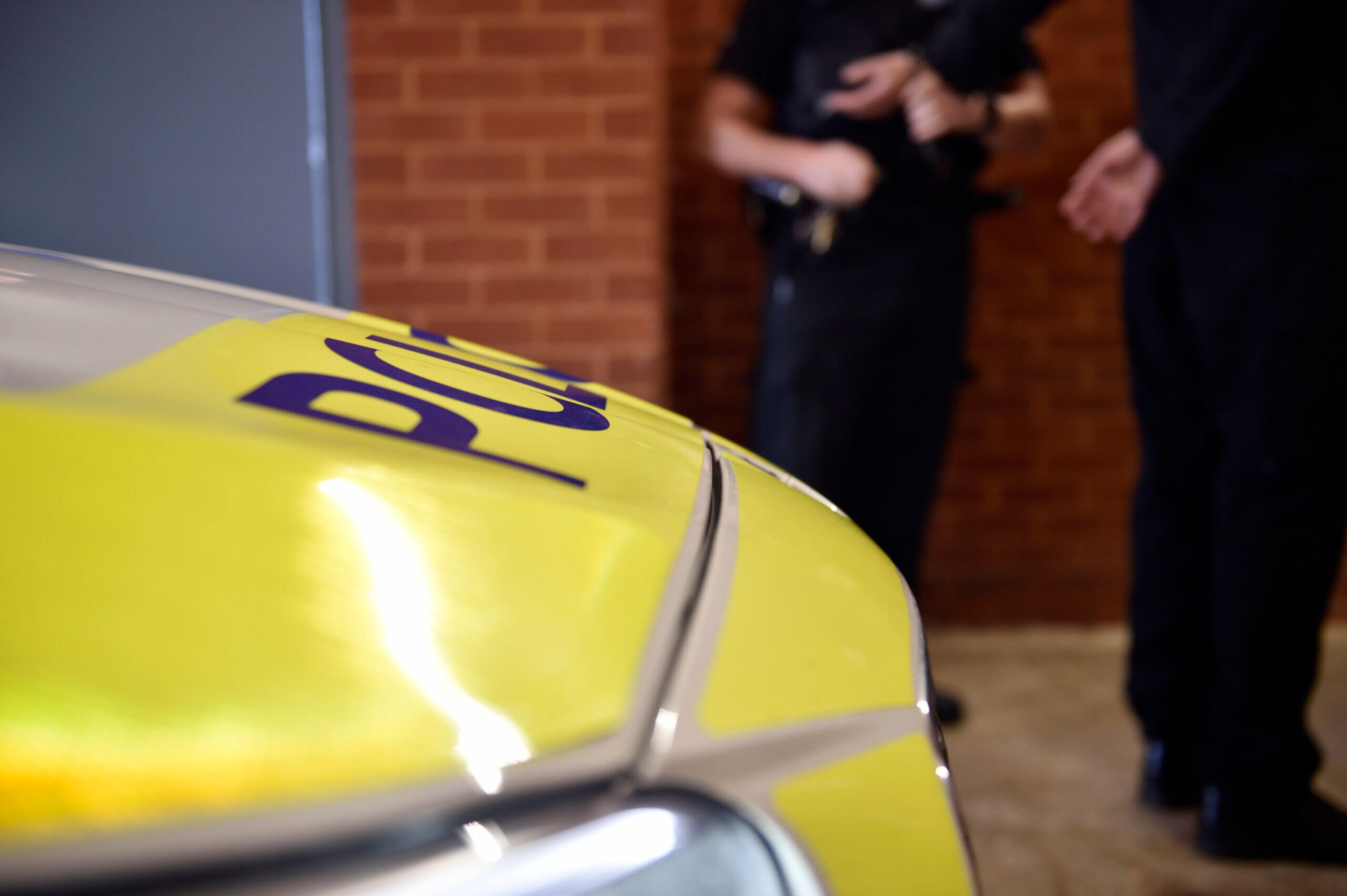 A police officer with a suspect at custody.