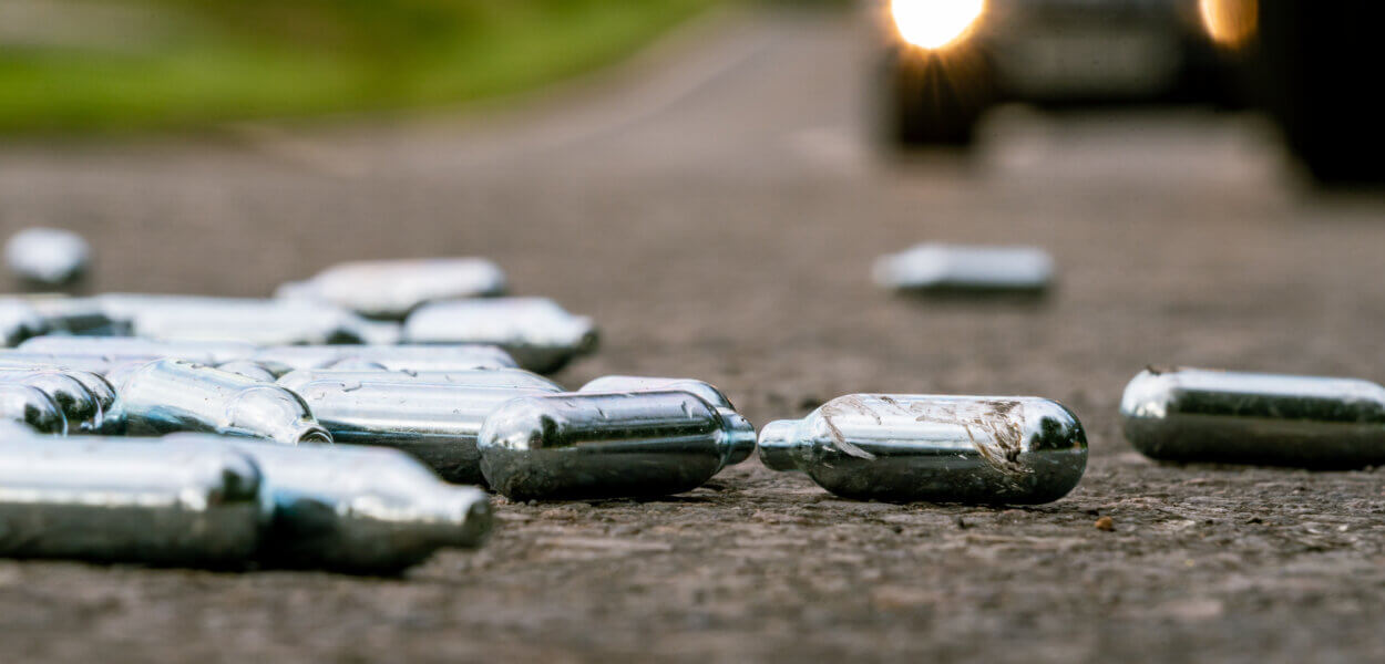Discarded Nitrous Oxide gas canisters in roadside layby